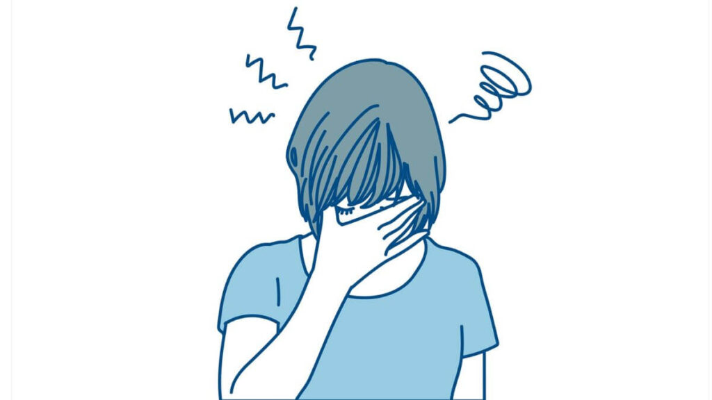手を顔に当て落ち込む若い女性