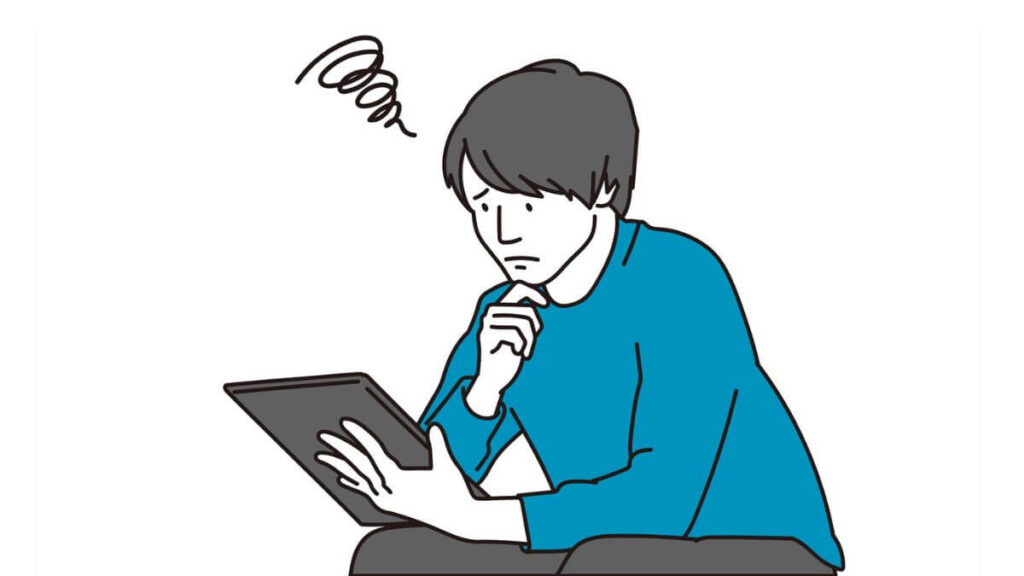 タブレットを見ながら難しい表情をする男性