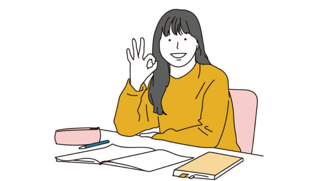 OKサインを出しながら仕事をする女性