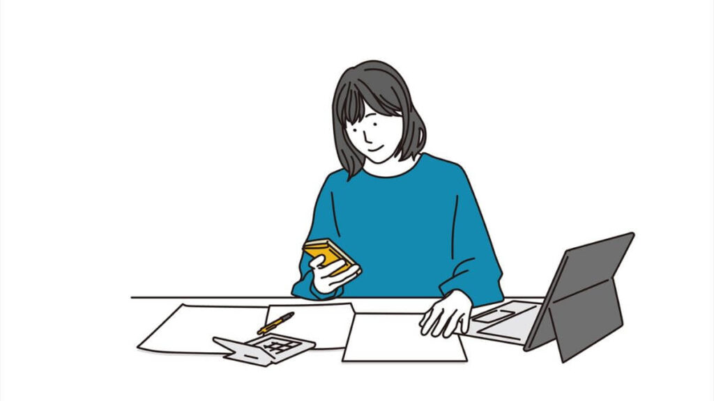 スマホとノートを使って作業する女性