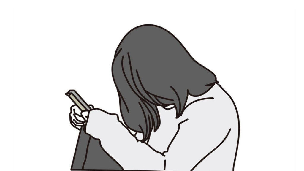 うずくまりながら座り落ち込む女性