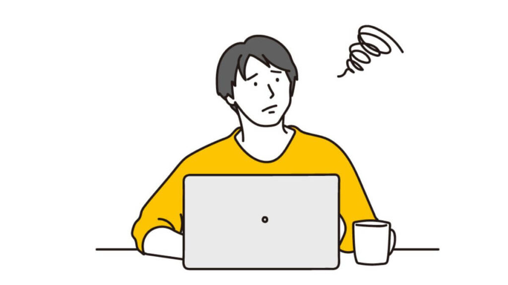 パソコンをしながら困った表情をする若い男性