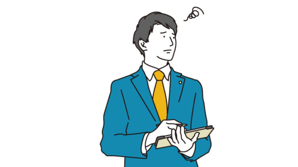 困った表情をしながら仕事をする男性