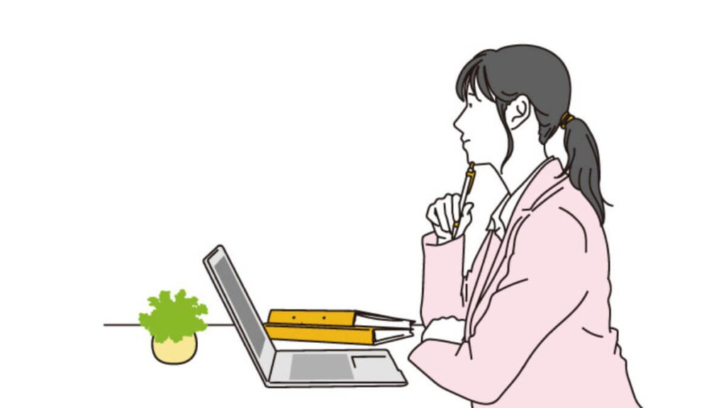 仕事中にペンを顎に置き考えるスーツ姿の女性