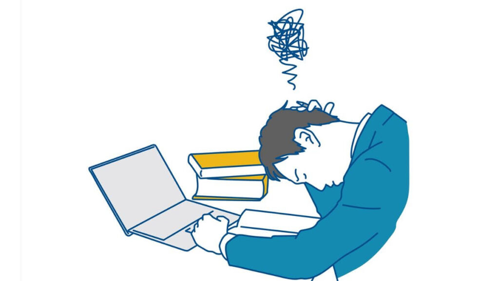 仕事中に頭を下げて落ち込む男性