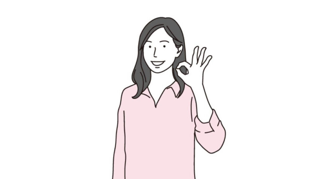 OKサインを出す若い女性