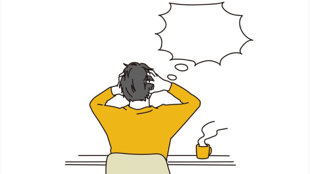 悩んで頭を抱える若い男性