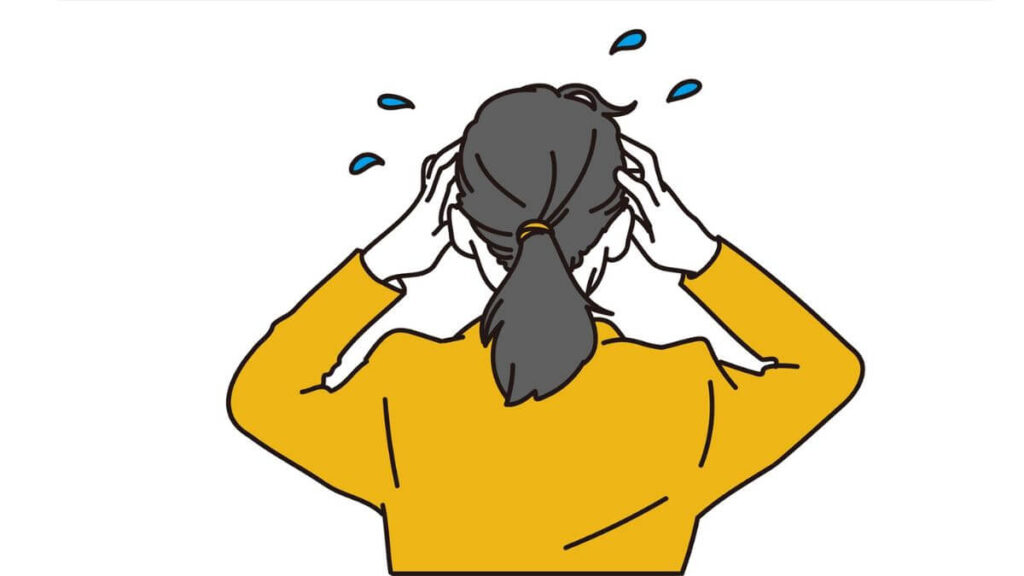 両手で頭を押さえて慌てる女性