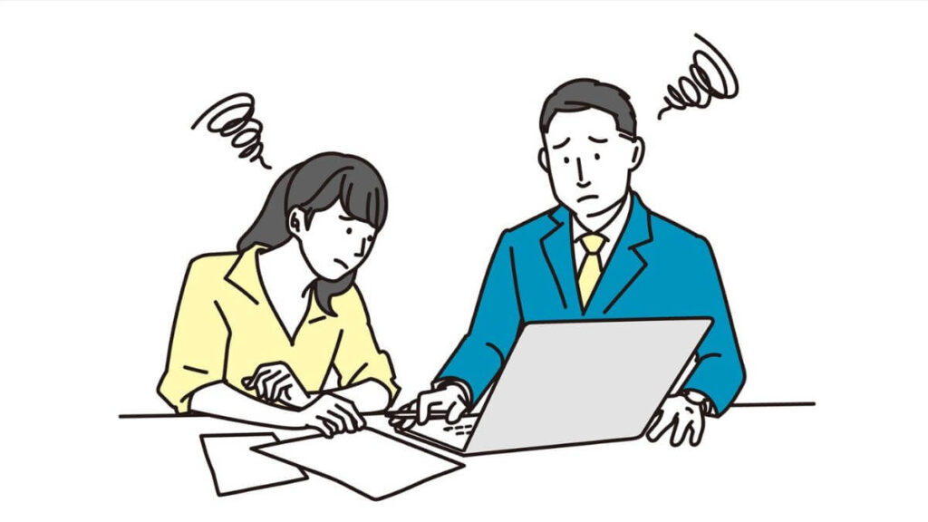 会議中に困った表情をする男女