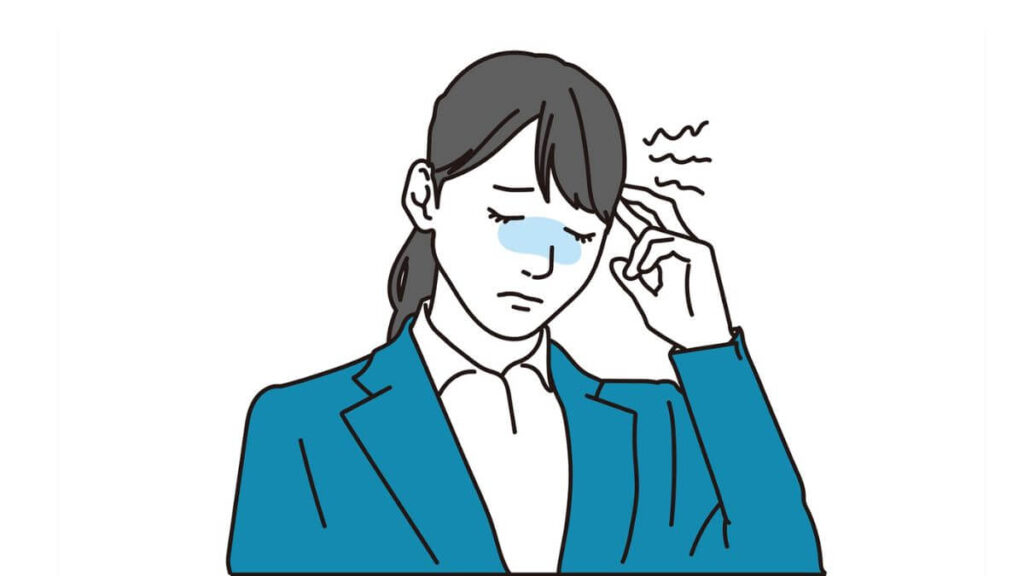 指を顔に当てて苦しむスーツ姿の女性