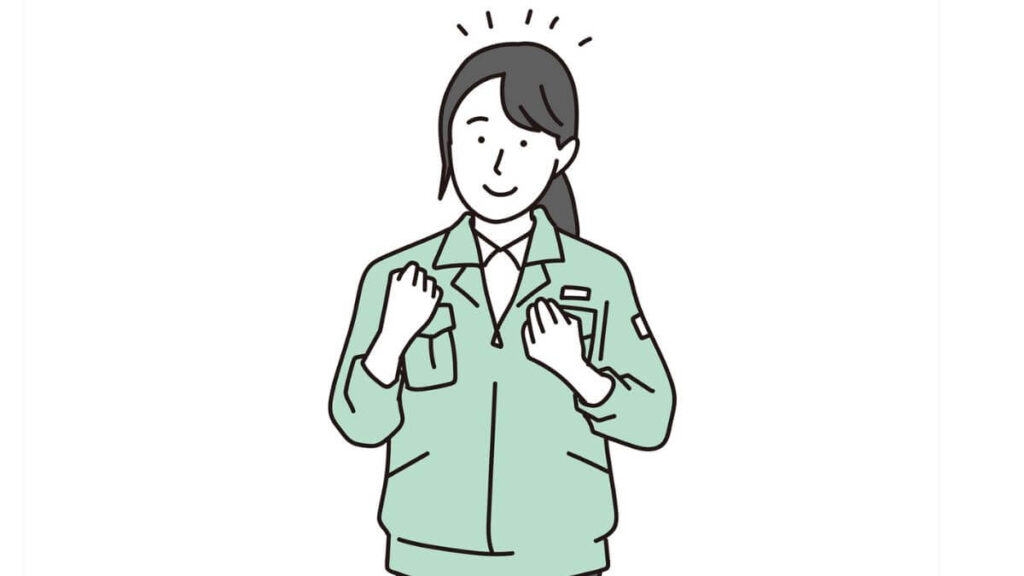 ガッツポーズをする作業着姿の女性