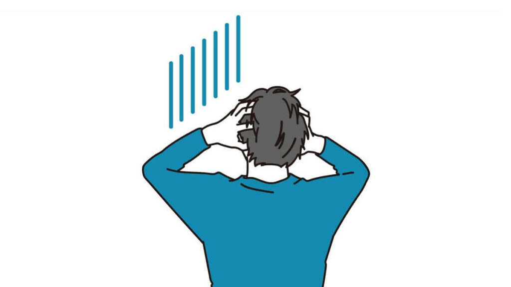 頭を抱え悩んでいる男性
