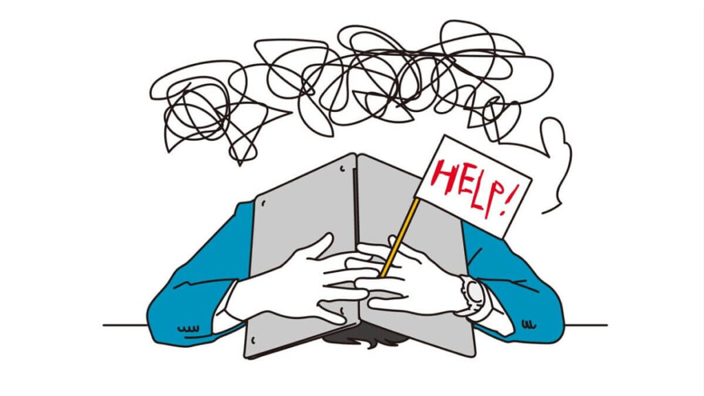 ノートパソコンをかぶり頭を抱えるスーツ姿の男性