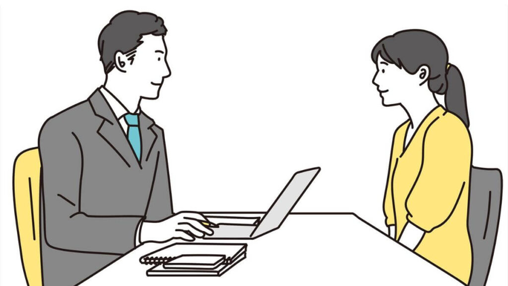 スーツ姿の男性に相談する若い女性