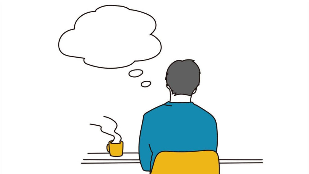 椅子に座り物思いに耽る男性