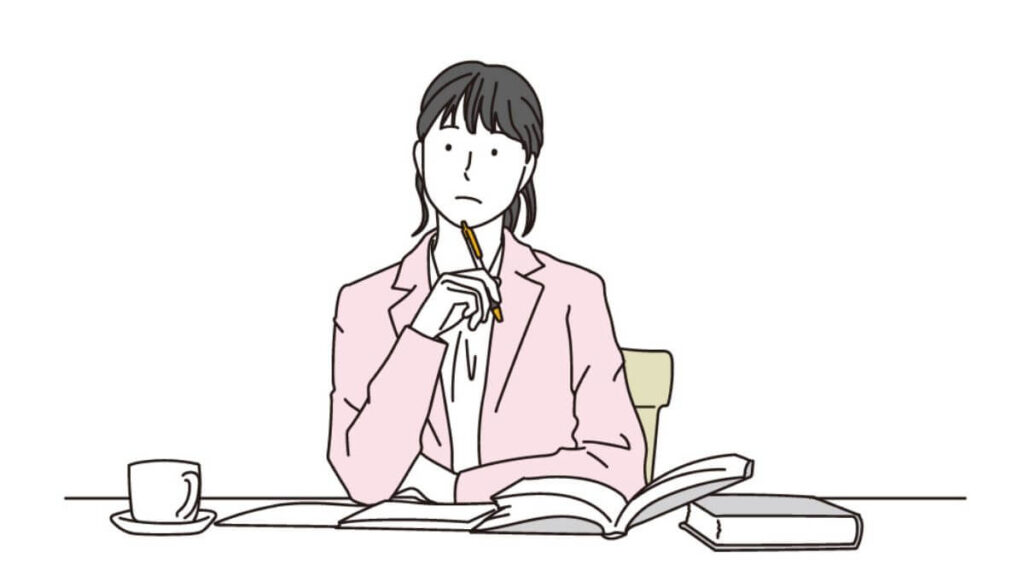 顎にペンを置き考えてごとをする女性