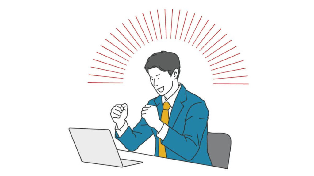 パソコン前でガッツポーズをするスーツ姿の男性