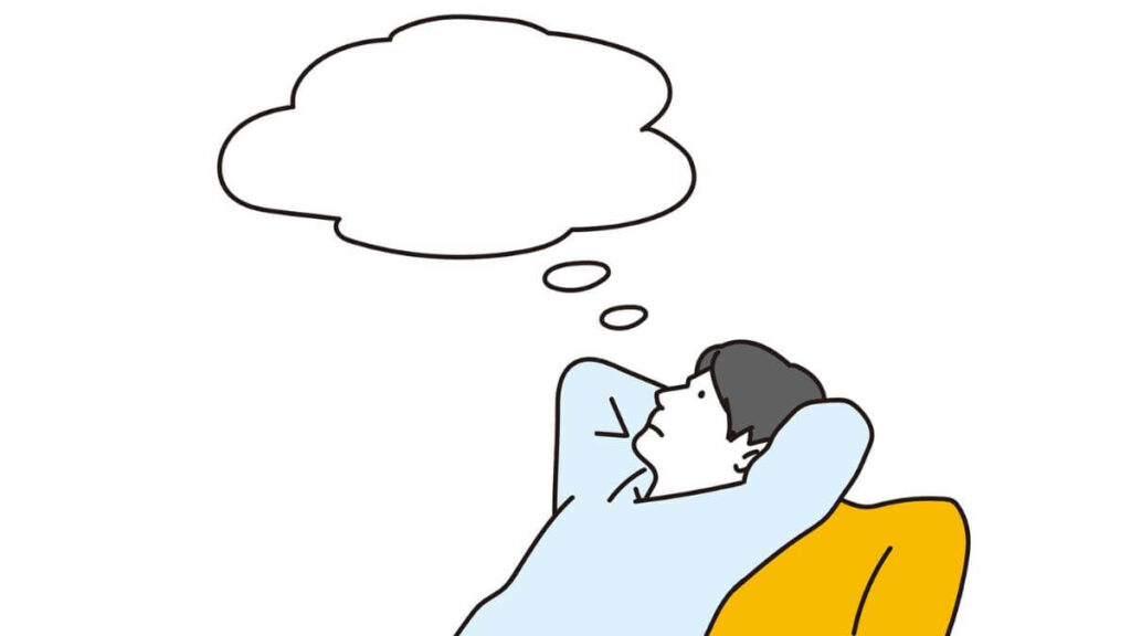 ソファーに座り考え事をする男性