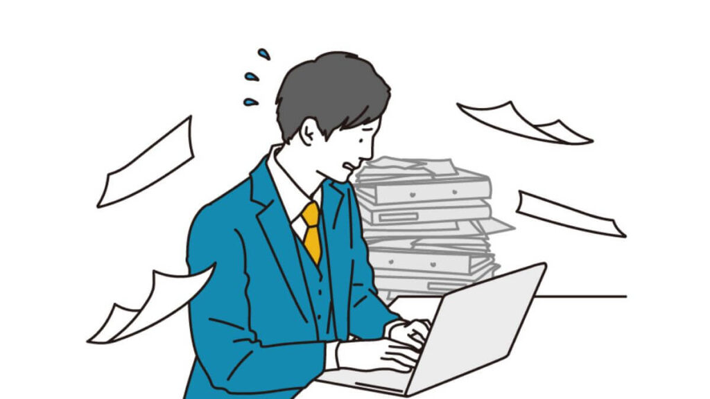 仕事が山積みで忙しいスーツ姿の男性