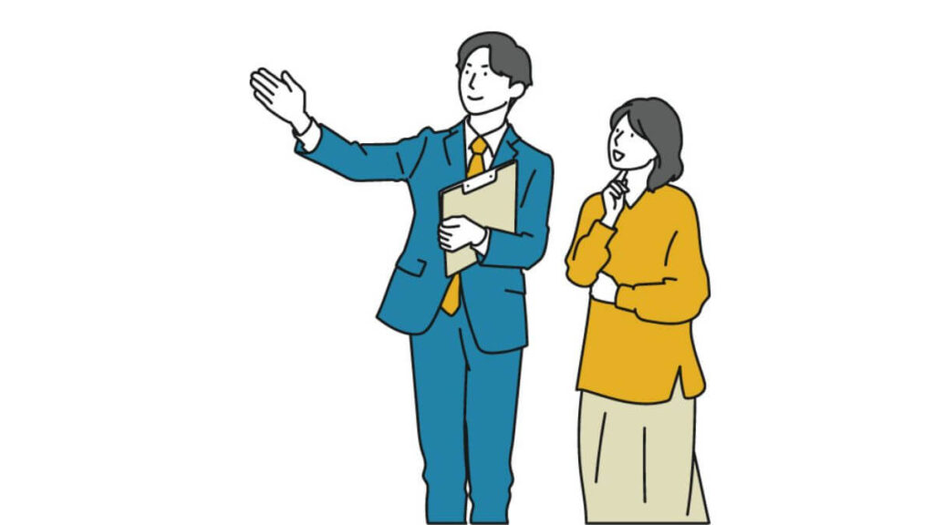 お客さんを案内するスーツ姿の男性