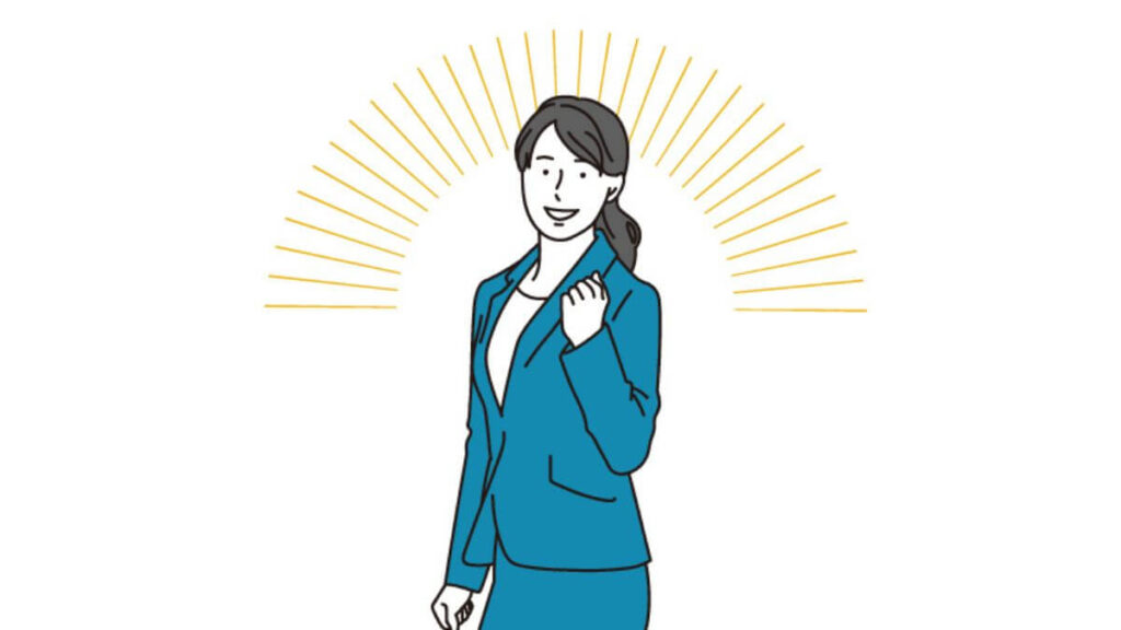 拳を上げて笑顔のスーツ姿の若い女性