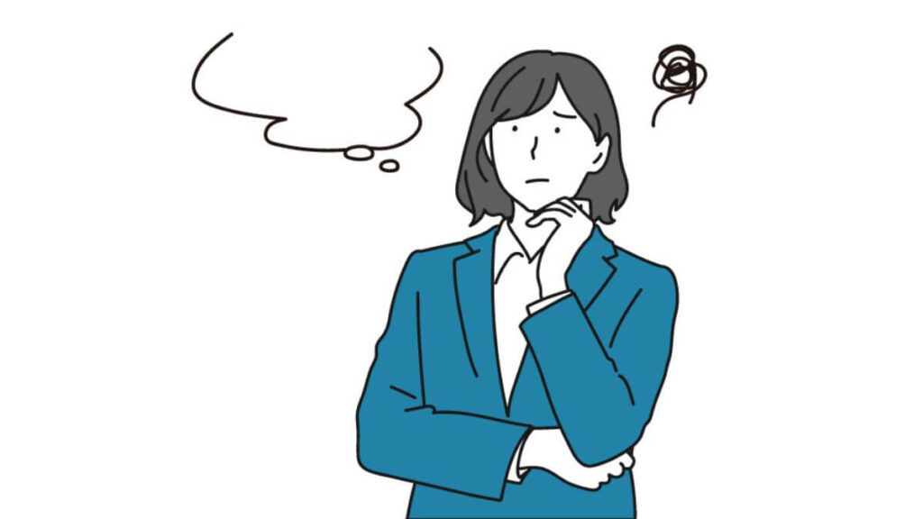 困った顔で考え込むスーツ姿の女性