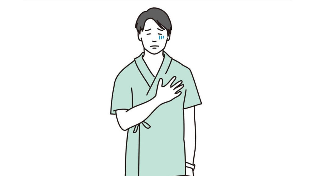 胸に手を置き体調が悪そうな男性