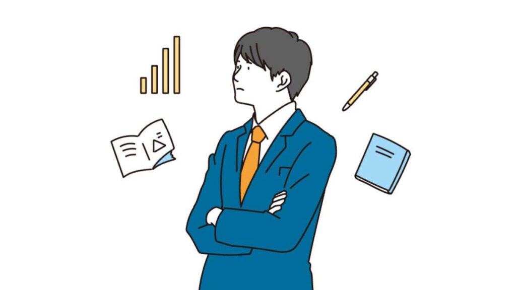 腕を組み考え事をするスーツ姿の若い男性