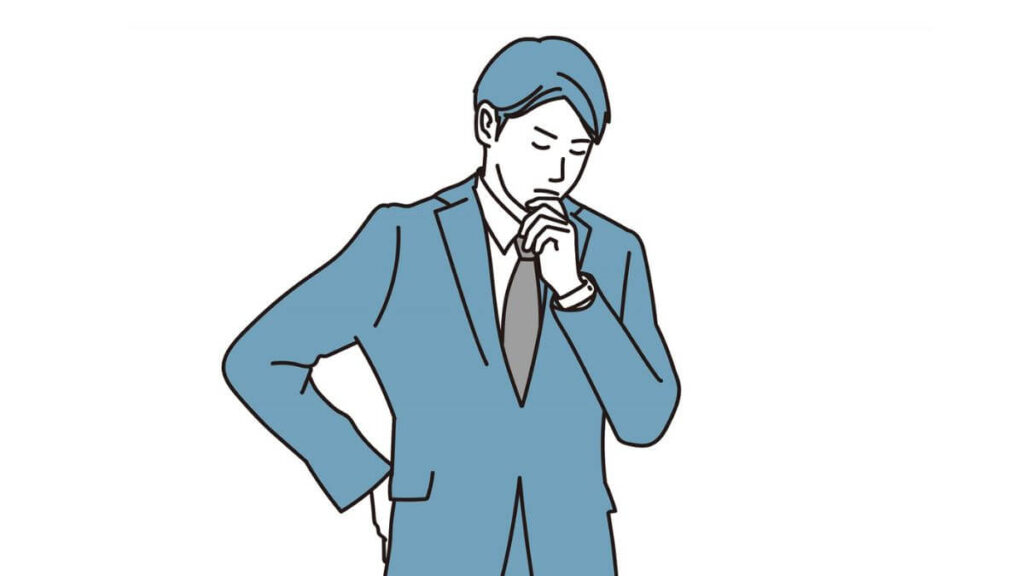 考え事をするスーツ姿の若い男性