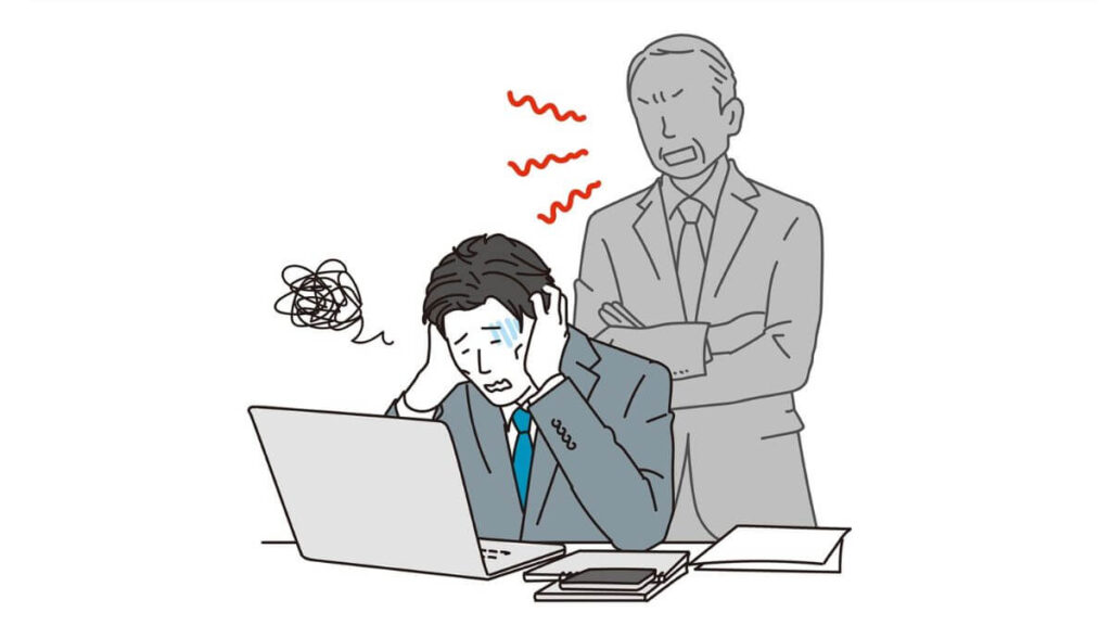 上司に怒られ萎縮するスーツ姿の男性