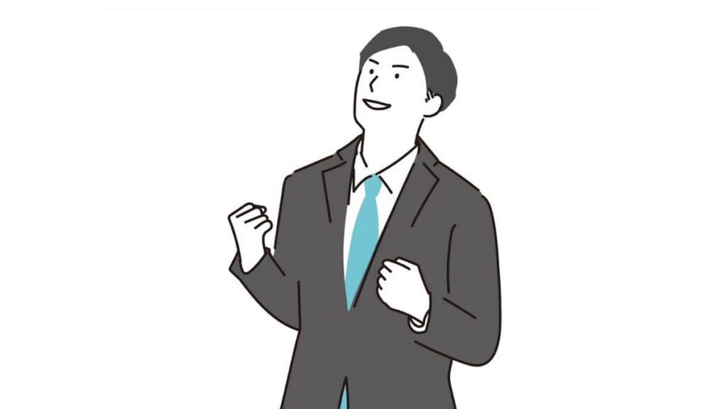 上を見上げてガッツポーズをする若い男性