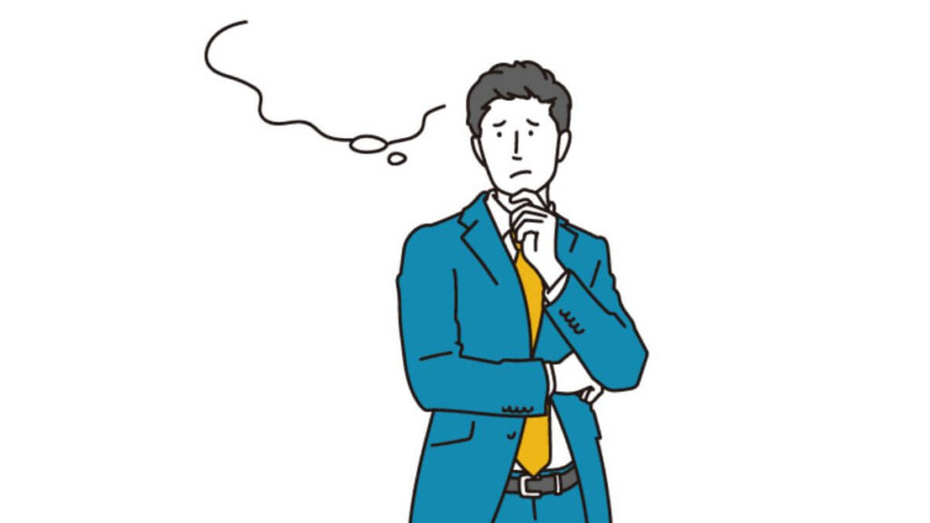 顎に手を置き考えるスーツ姿の男性