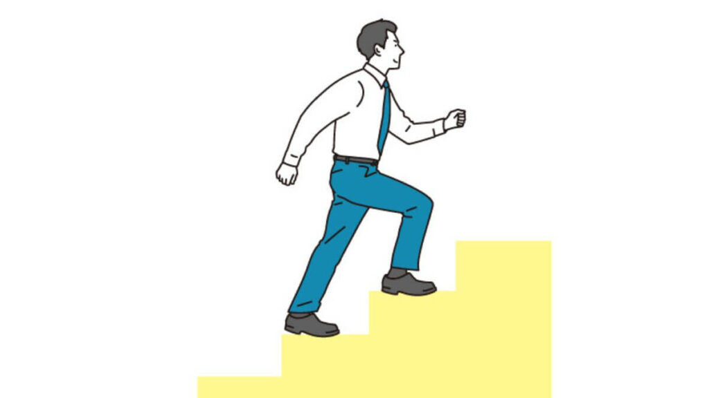 笑顔で階段を登るスーツ姿の男性