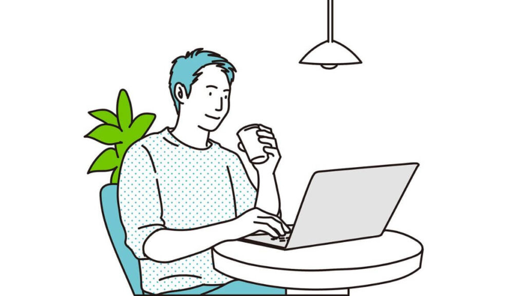 コーヒーを片手にパソコン作業をする若い男性