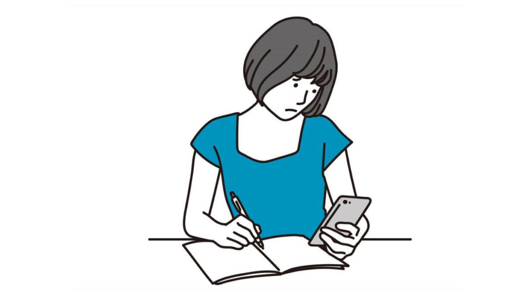 困った表情でスマホを見る若い女性