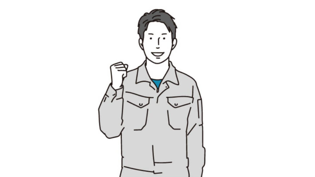 ガッツポーズをする作業着姿の若い男性