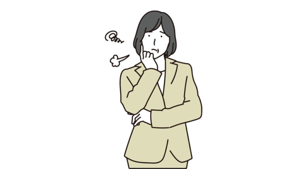 頬に手をつき困惑するスーツ姿の女性