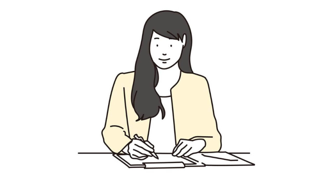 メモに文章を書くスーツ姿の女性