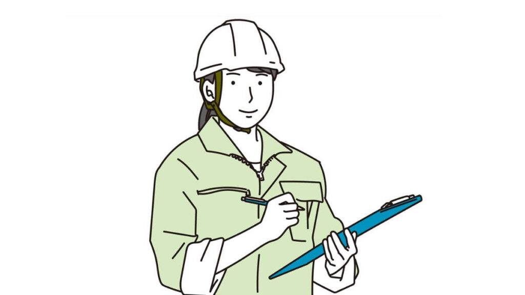 バインダーを持ち笑顔の作業着姿の女性