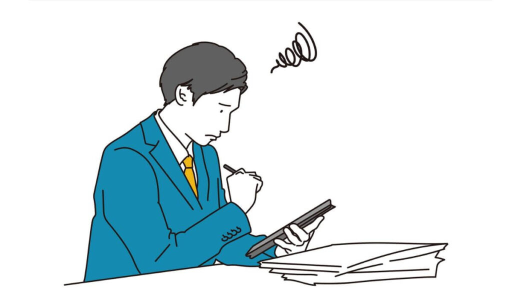 タブレットを持ち困った表情のスーツ姿の男性