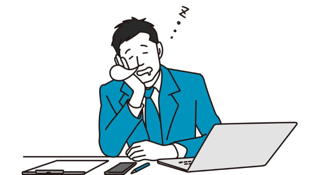 仕事に飽きて眠るスーツ姿の男性