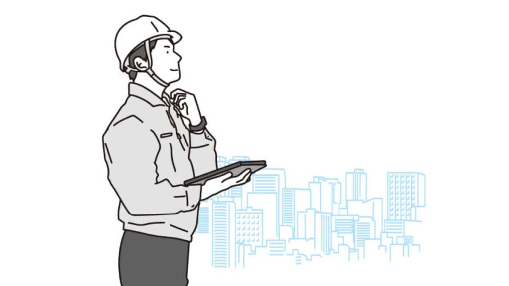 タブレットを持ち仕事をする作業着姿の男性