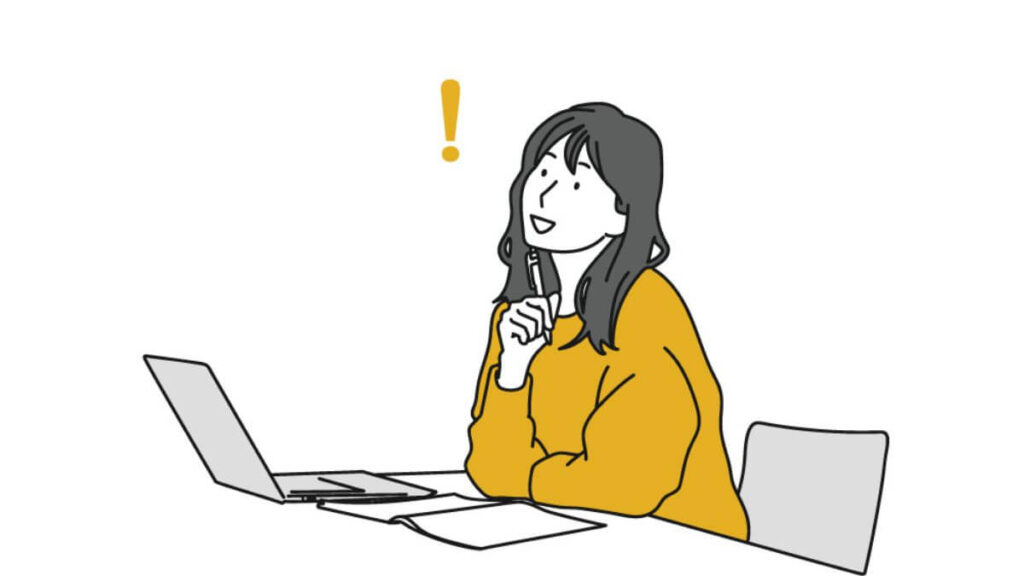 パソコンの前で何かを閃く若い女性