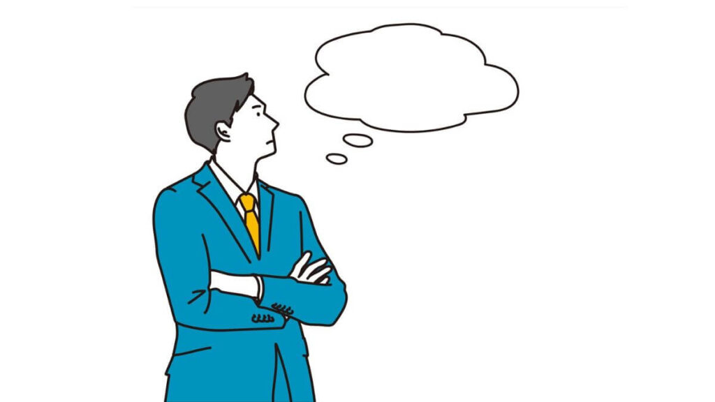 腕を組んで考え事をするサラリーマン