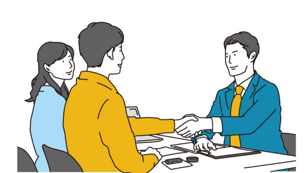 お客さんと握手をするサラリーマン