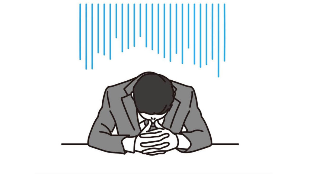 両手を組んで落ち込むサラリーマン