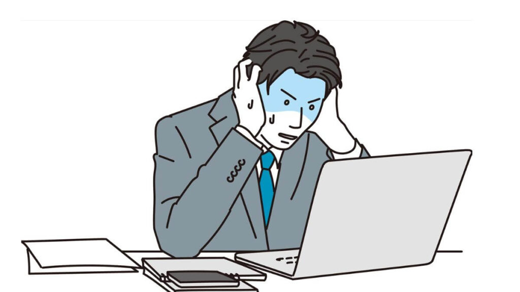 両手を頭に置いて焦るサラリーマン