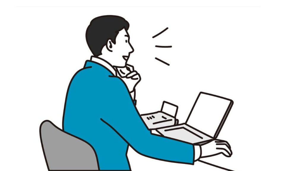 電話をしながらパソコン作業をするサラリーマン