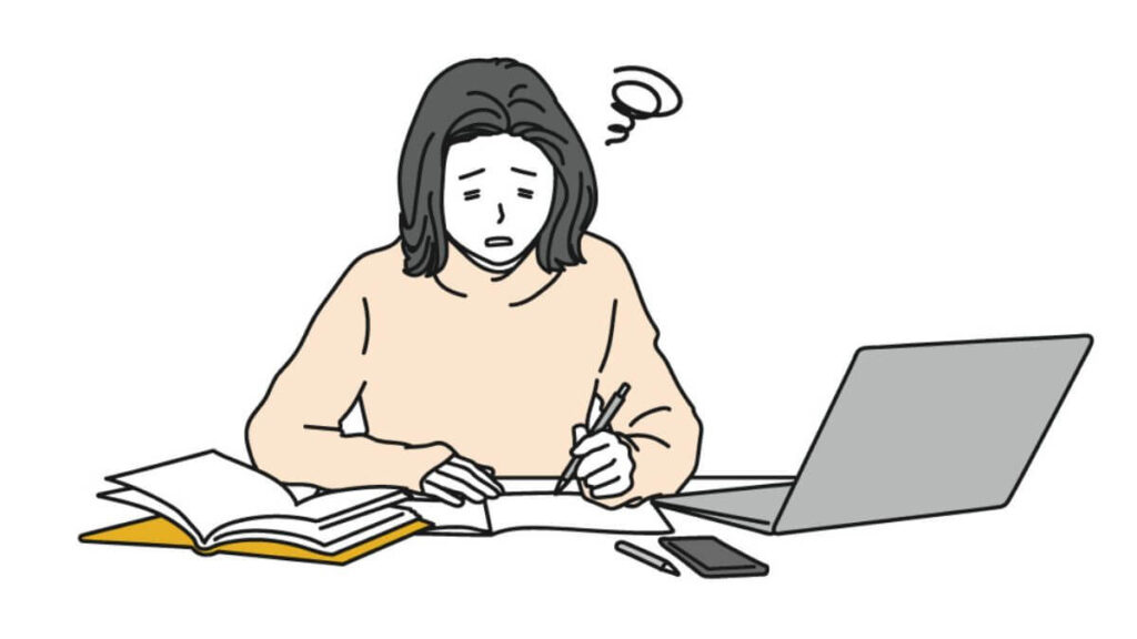 困った表情をしながらメモを書く女性