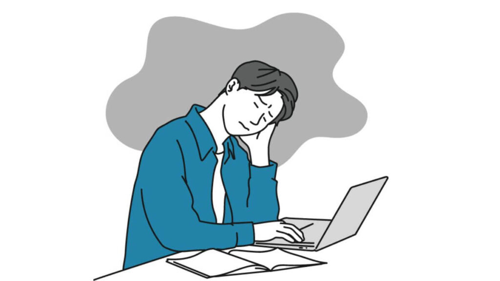 頭を傾げながら仕事をする若い男性